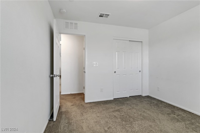 unfurnished bedroom with a closet and carpet