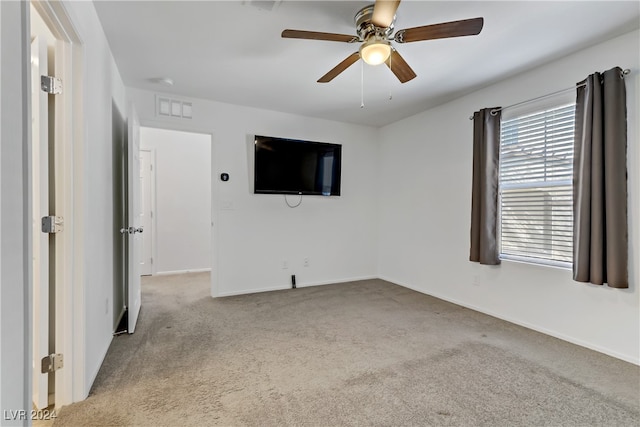 unfurnished room featuring ceiling fan and light carpet