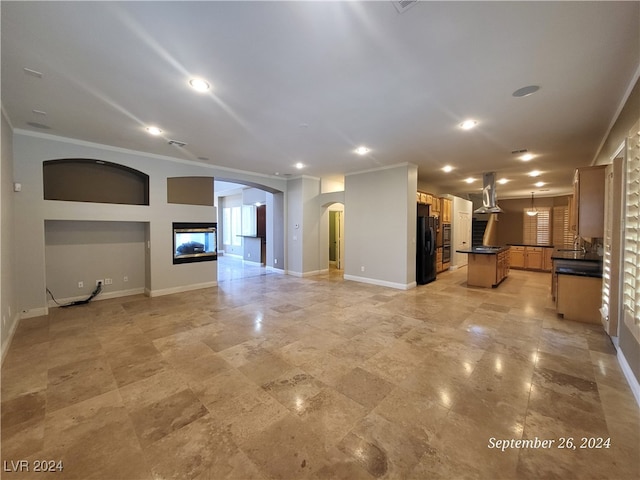 unfurnished living room featuring ornamental molding