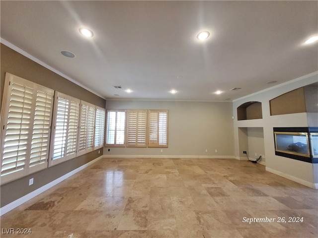 unfurnished living room featuring crown molding