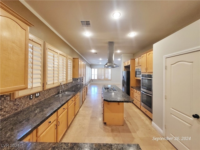 kitchen with sink, island range hood, stainless steel appliances, a center island, and dark stone counters