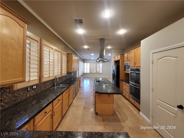 kitchen featuring a kitchen island, stainless steel appliances, dark stone countertops, sink, and island range hood