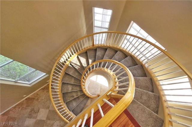 1337 Via Savona Dr, Henderson, NV 89052 - stairs featuring plenty of natural light, a towering ceiling, and a skylight