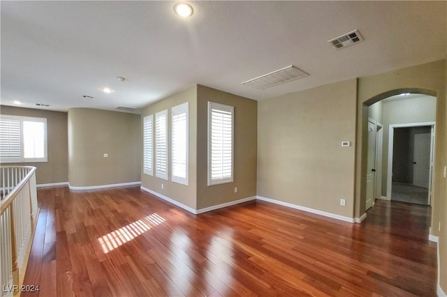 1337 Via Savona Dr, Henderson, NV 89052 - unfurnished room with arched walkways, wood finished floors, baseboards, and recessed lighting