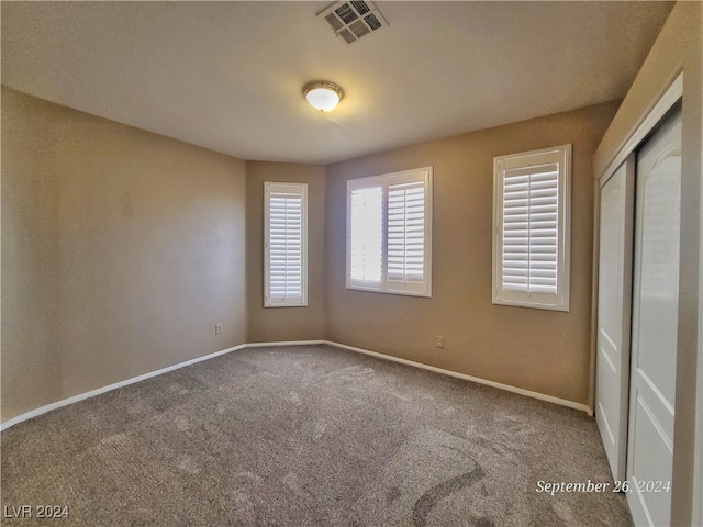 unfurnished room with carpet flooring