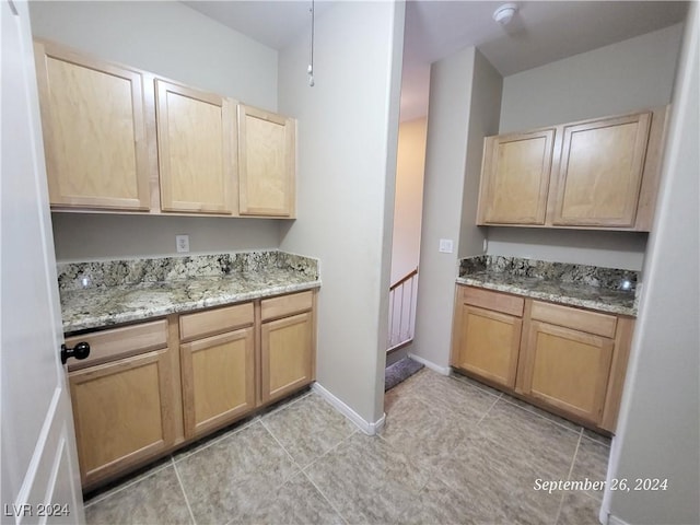 1337 Via Savona Dr, Henderson, NV 89052 - kitchen featuring light brown cabinetry, light stone countertops, and baseboards
