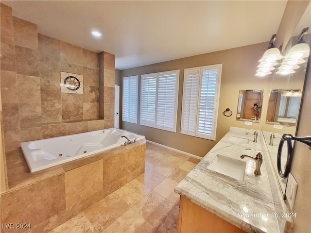 bathroom with vanity and tiled bath