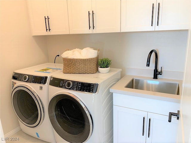 laundry room with cabinets, independent washer and dryer, and sink