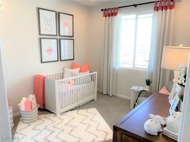 carpeted bedroom featuring a crib