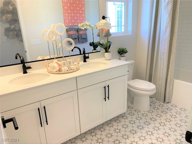 full bathroom with vanity, shower / tub combo with curtain, and toilet