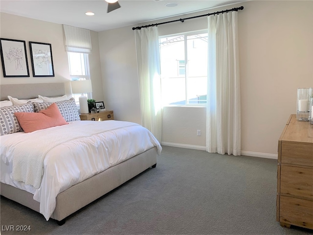 carpeted bedroom with multiple windows and ceiling fan