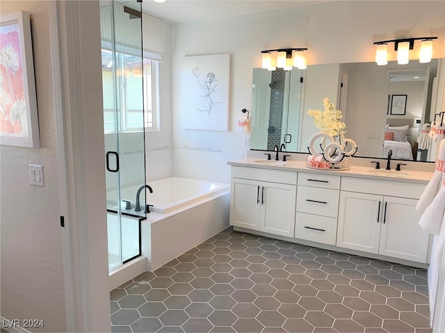 bathroom featuring vanity, shower with separate bathtub, and tile patterned floors