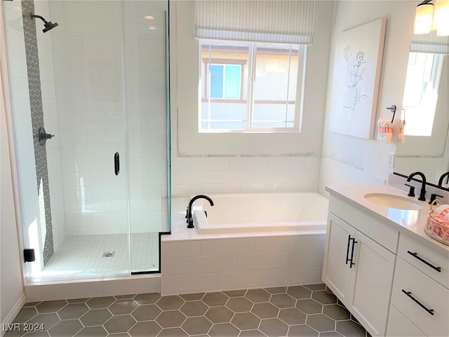 bathroom with vanity, independent shower and bath, and tile patterned floors