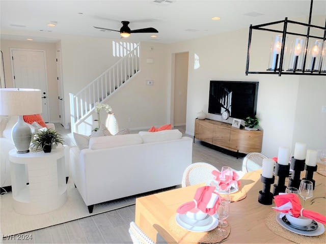 living room featuring light hardwood / wood-style floors and ceiling fan