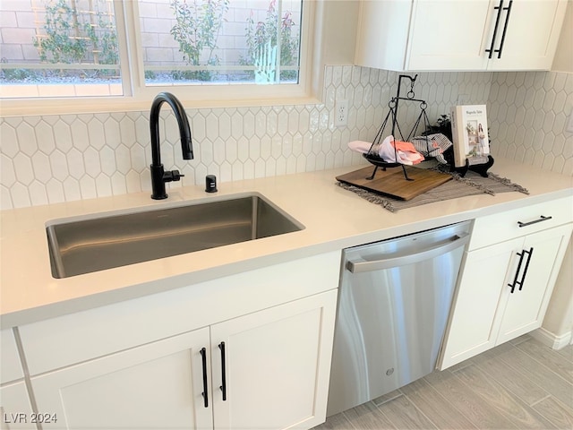 kitchen with sink, white cabinetry, dishwasher, and plenty of natural light