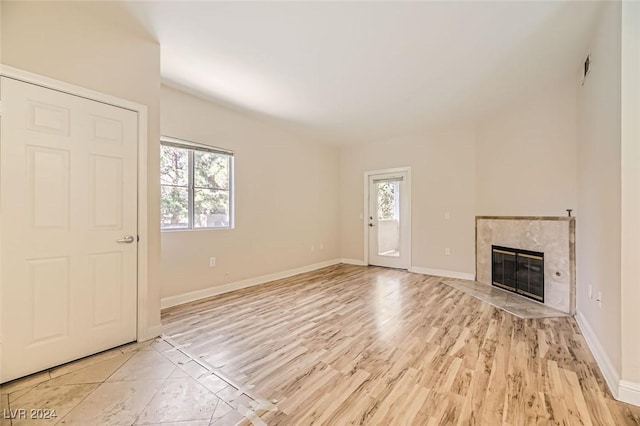 unfurnished living room featuring light hardwood / wood-style flooring and a fireplace