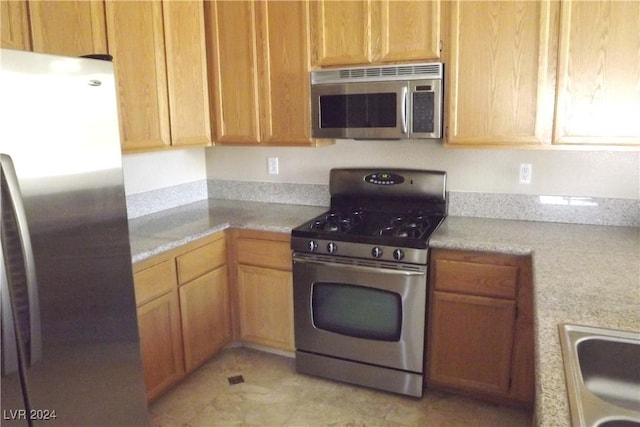 75 N Valle Verde Dr Unit 225, Henderson, NV 89074 - kitchen featuring appliances with stainless steel finishes, light tile patterned floors, and a sink