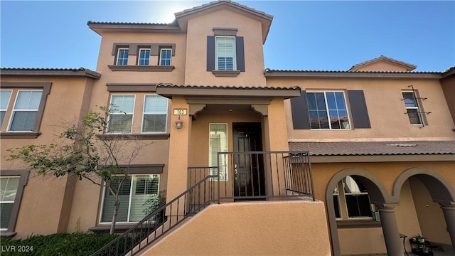 11404 Belmont Lake Dr Unit 103, Las Vegas, NV 89135 - view of front of house with stucco siding and a tile roof