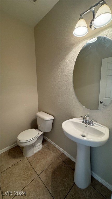 bathroom with sink, toilet, and tile patterned floors