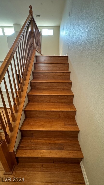 stairs featuring wood-type flooring