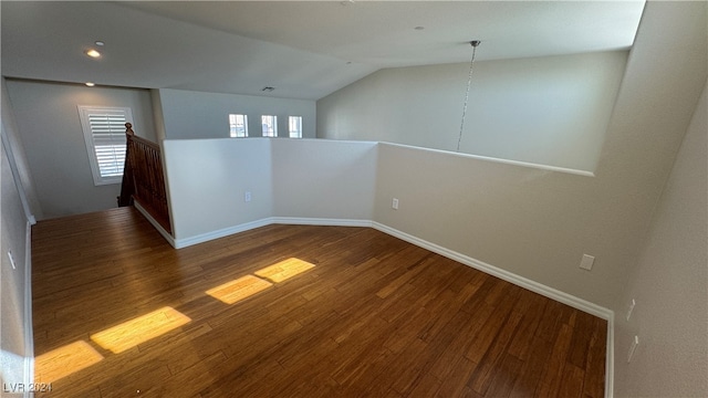 unfurnished room with lofted ceiling and hardwood / wood-style floors