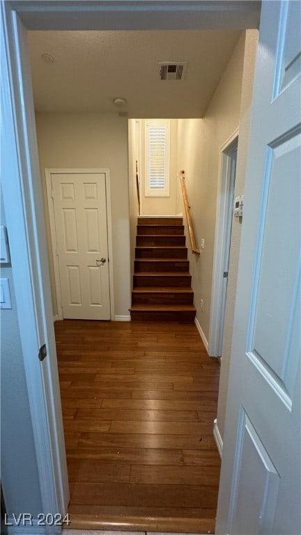 staircase featuring wood-type flooring