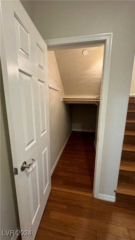 hallway with dark hardwood / wood-style floors