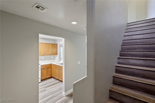 stairs featuring wood-type flooring