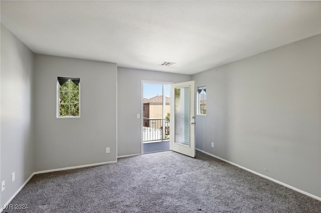 carpeted spare room with a healthy amount of sunlight