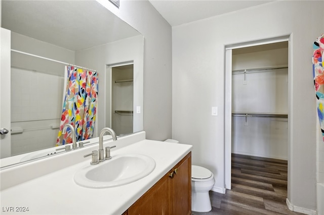 bathroom with vanity, hardwood / wood-style flooring, and toilet