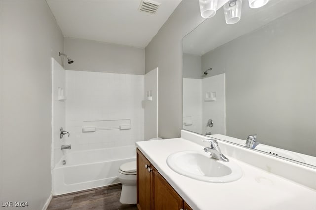 full bathroom featuring toilet, hardwood / wood-style floors, vanity, and bathing tub / shower combination