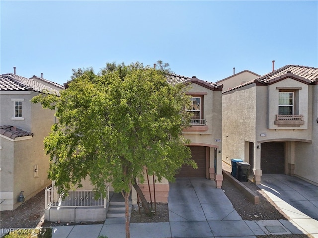 mediterranean / spanish-style home with a garage