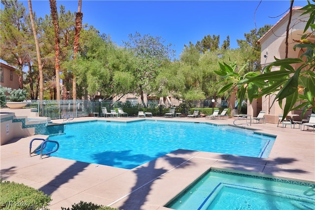 view of pool featuring a community hot tub and a patio