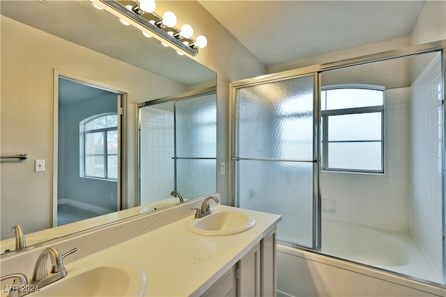 bathroom with shower / bath combination with glass door and vanity