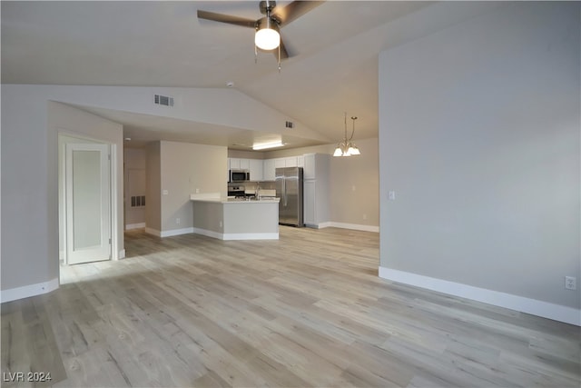 unfurnished living room with ceiling fan with notable chandelier, vaulted ceiling, and light hardwood / wood-style flooring