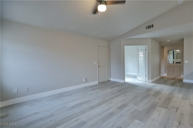 empty room featuring ceiling fan, light hardwood / wood-style floors, and lofted ceiling