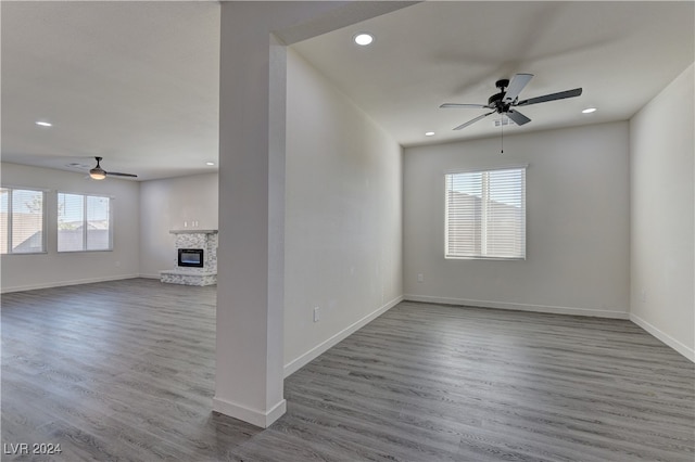 unfurnished living room featuring ceiling fan and wood-type flooring