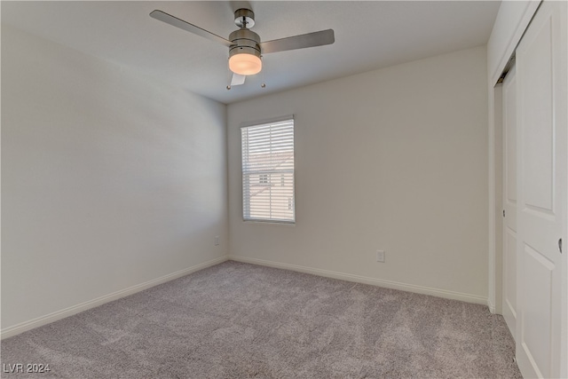 unfurnished bedroom featuring a closet, light carpet, and ceiling fan