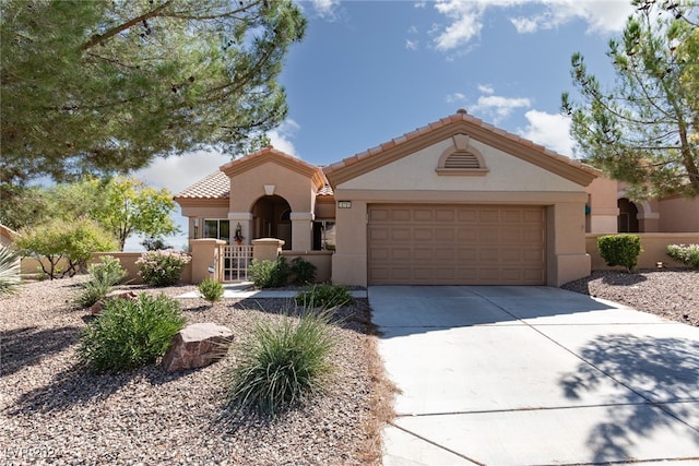 mediterranean / spanish-style home with a garage