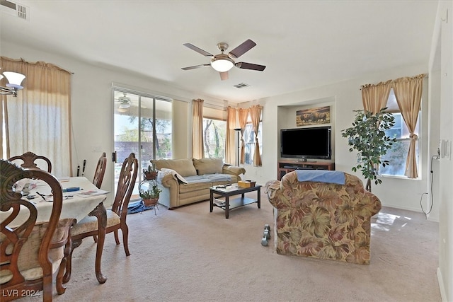 carpeted living room featuring ceiling fan