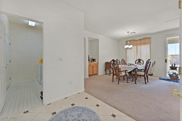 carpeted dining area featuring a notable chandelier