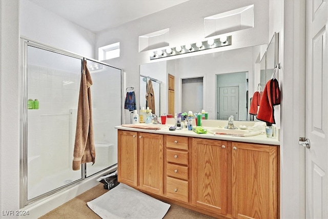 bathroom featuring vanity and an enclosed shower