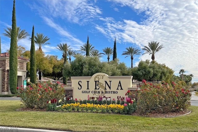 community / neighborhood sign with a lawn