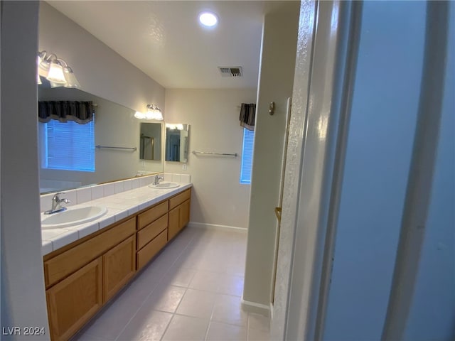 bathroom with tile patterned floors and vanity