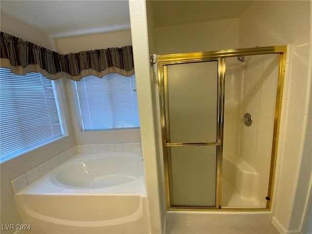 bathroom featuring tile patterned flooring and separate shower and tub