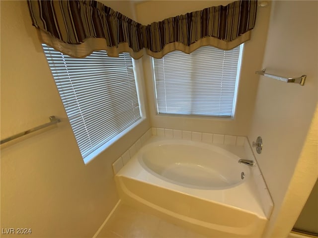 bathroom featuring a bathing tub, plenty of natural light, and tile patterned floors