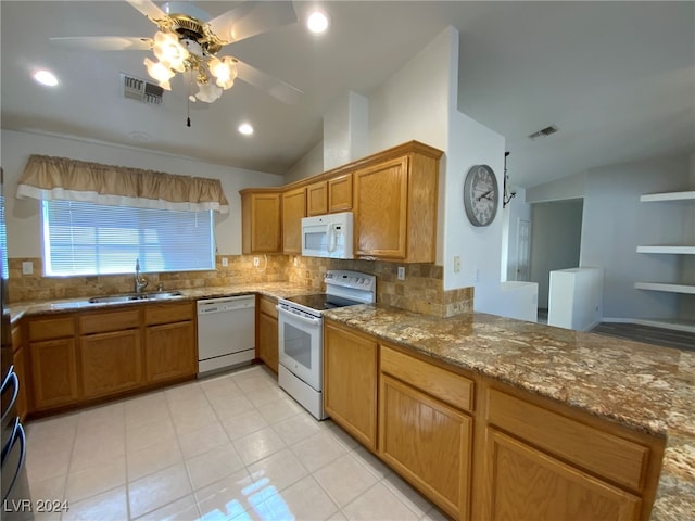 kitchen with sink, white appliances, stone countertops, backsplash, and vaulted ceiling