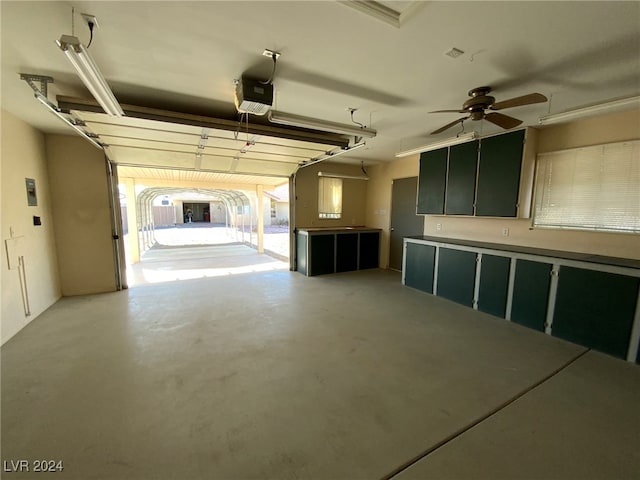 garage featuring a garage door opener and ceiling fan