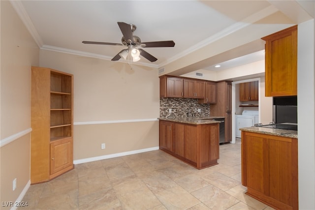 kitchen featuring ceiling fan, kitchen peninsula, tasteful backsplash, crown molding, and washer and dryer