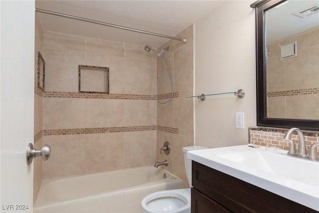 full bathroom featuring vanity, tiled shower / bath combo, toilet, and decorative backsplash